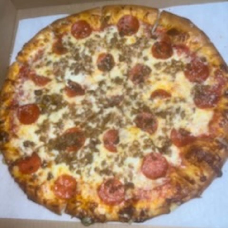A whole Pappy J's pizza with pepperoni and sausage toppings in a cardboard box.